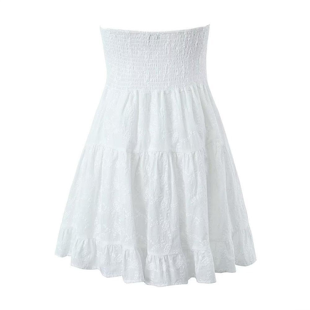 White strapless ruched dress with tiered ruffles, casual summer style.