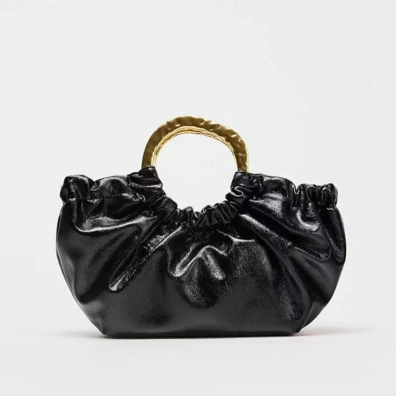 Black ruched handbag with gold handle, chic evening accessory