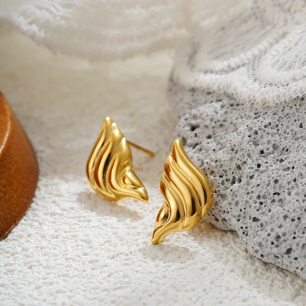 Gold abstract design stud earrings, elegant accessory for formal occasions.