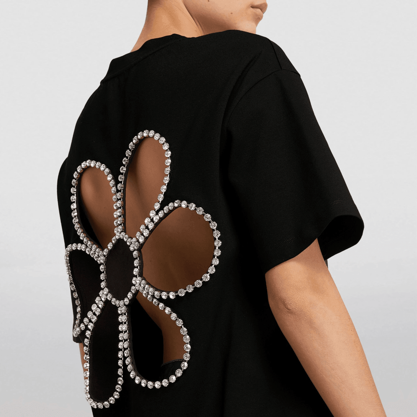 Cutout T-shirt with rhinestone floral design, chic and trendy casual look.