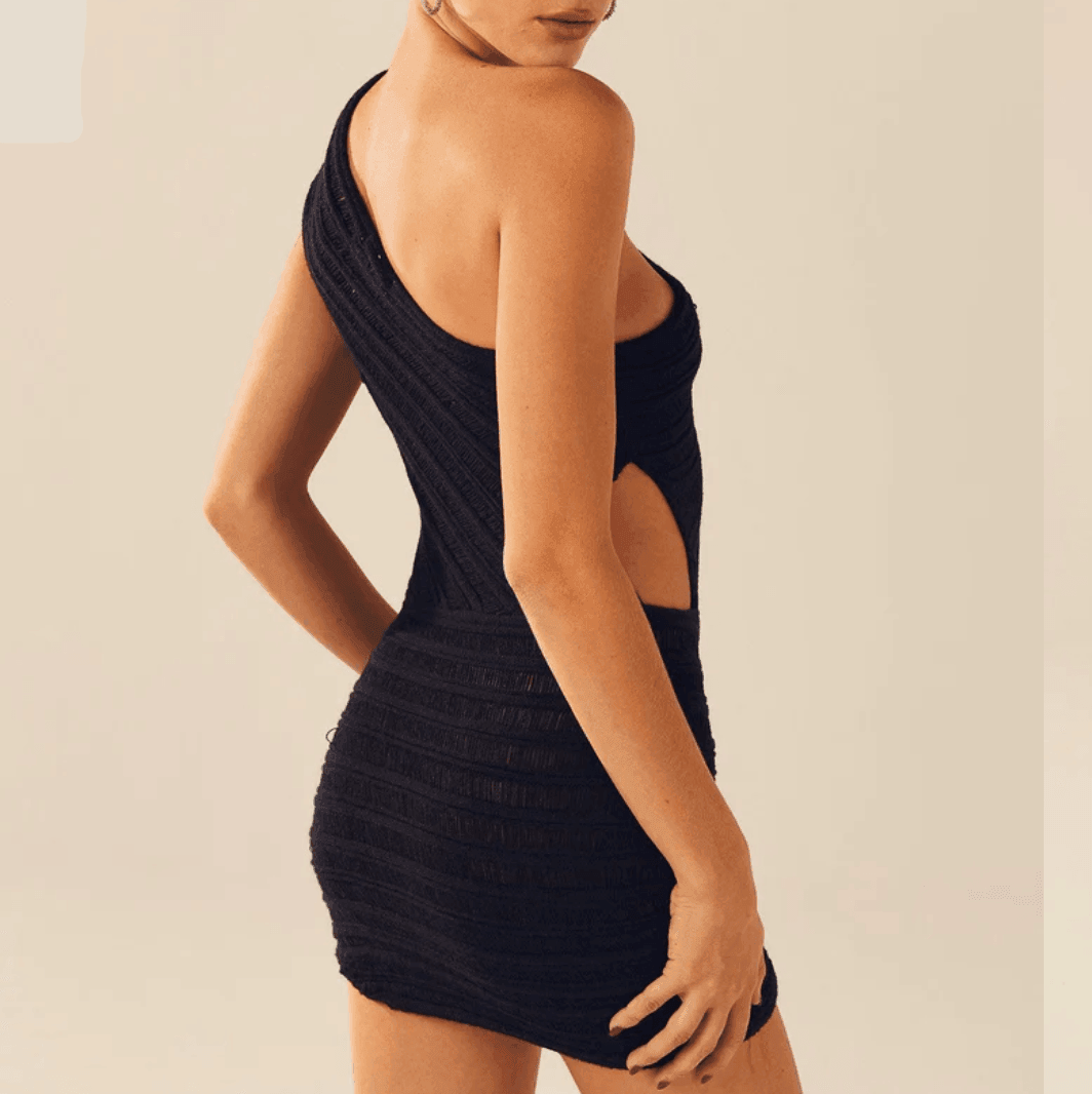 Black one-shoulder mini dress with textured fabric and cut-out details, styled for a chic evening look.