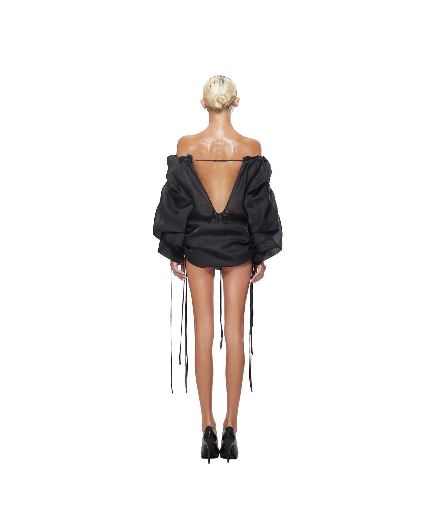 Off-the-shoulder backless mini dress with voluminous sleeves, party outfit.