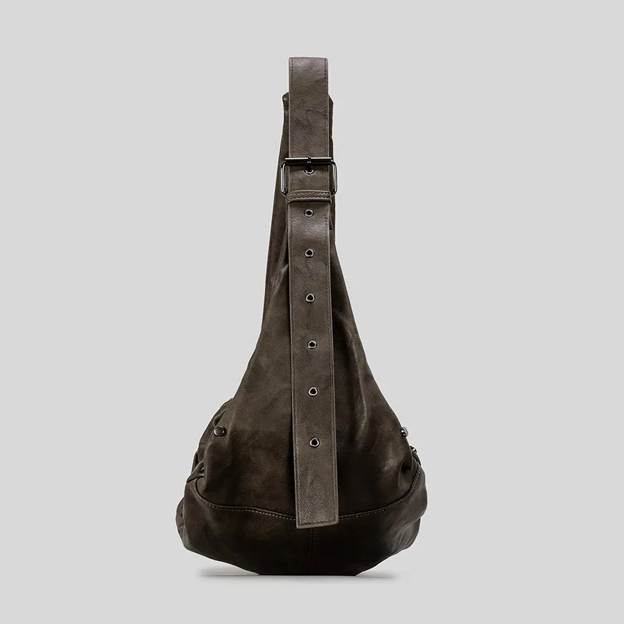 Sling-style leather bag with adjustable strap, casual accessory.