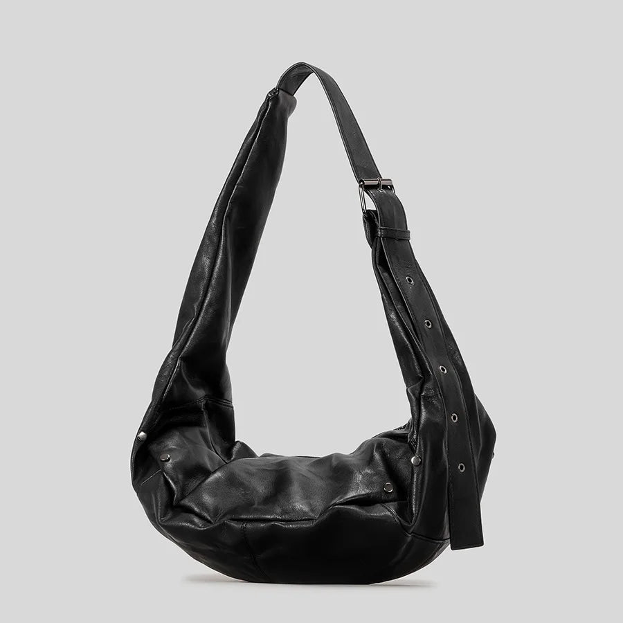 Black leather hobo bag with adjustable strap, versatile accessory for casual and chic looks.