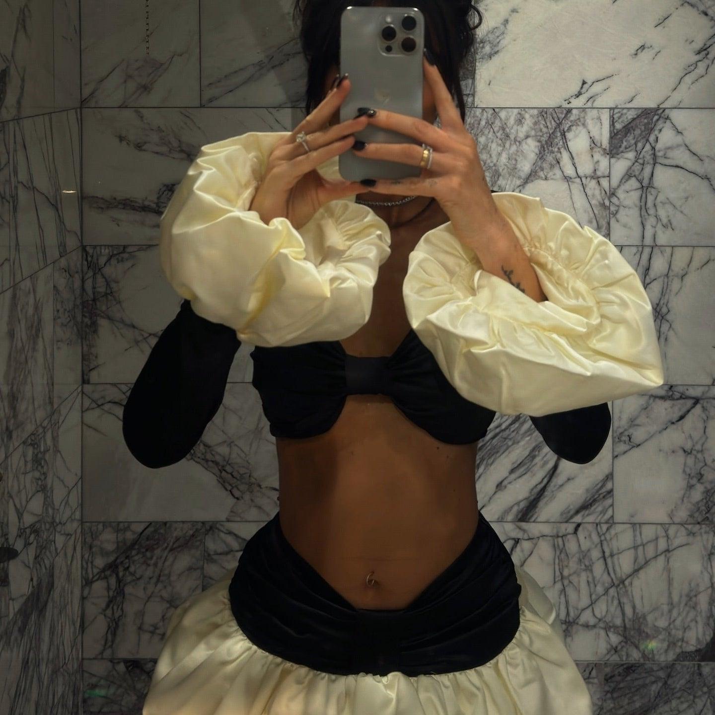 Black and cream satin co-ord with voluminous sleeves.