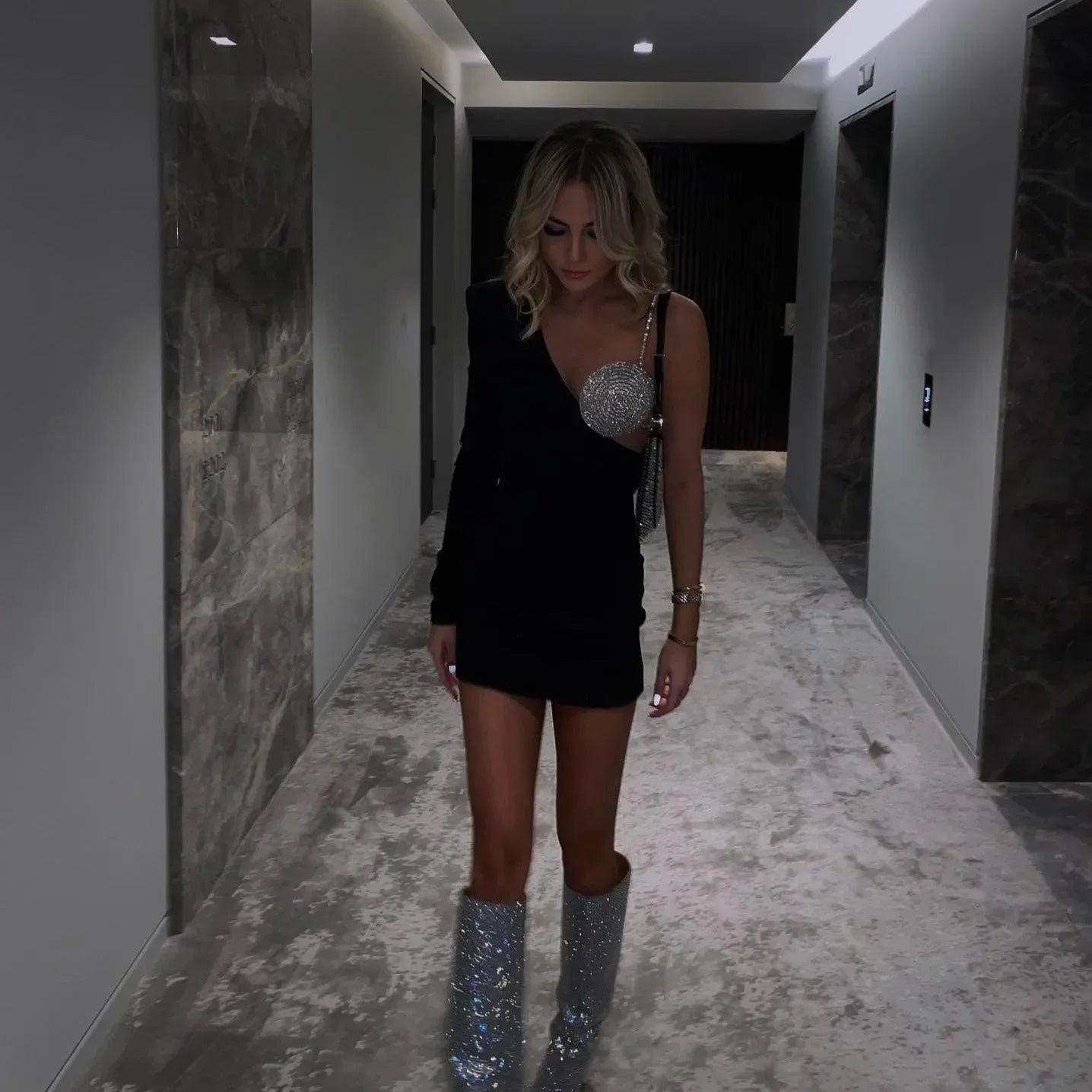 One-shoulder mini dress with sequin embellishment, paired with glitter knee-high boots, party