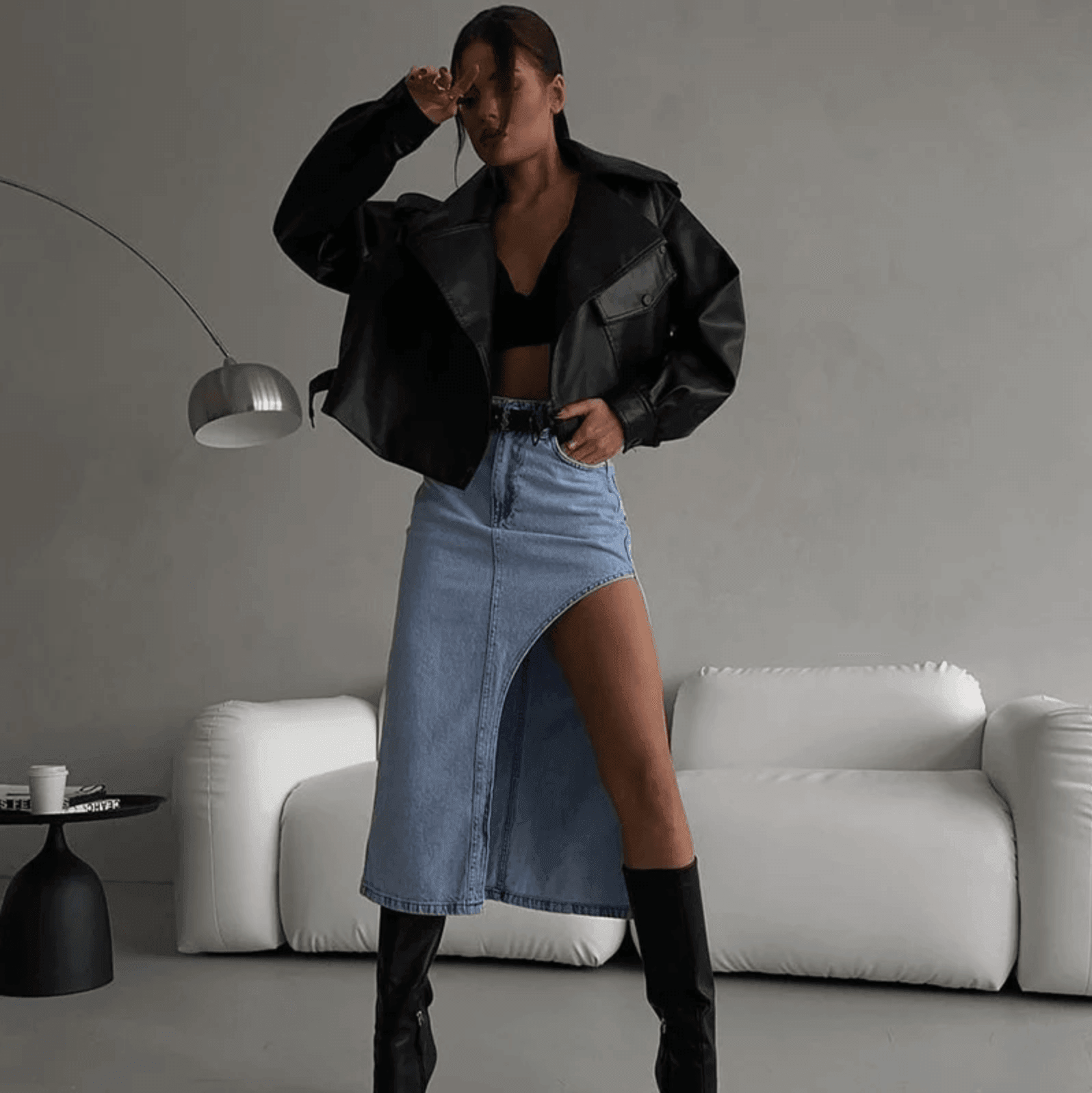 Black leather jacket with a blue denim asymmetrical skirt.