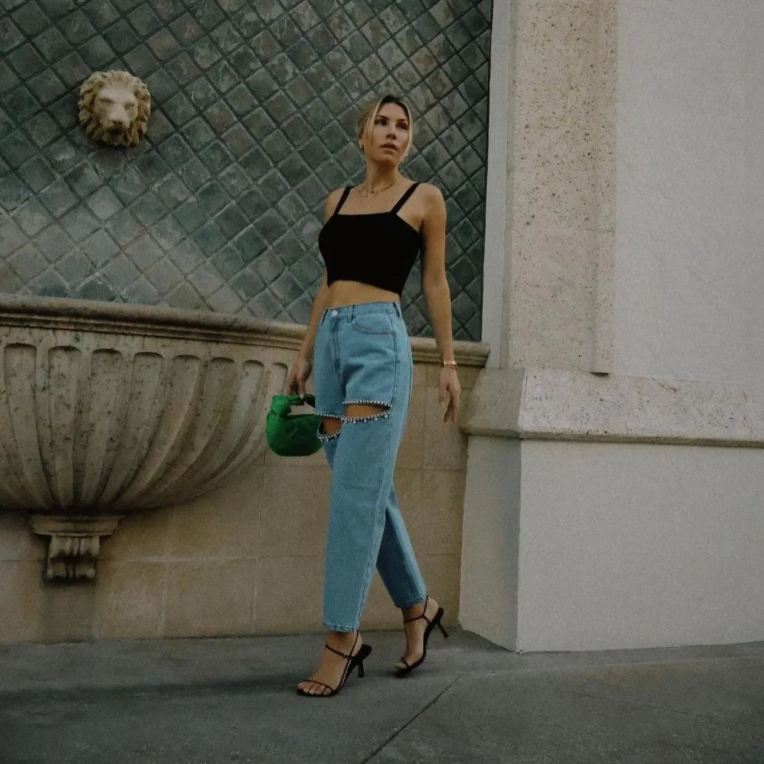 black strappy crop top with ripped jeans and green handbag, casual day-out fit