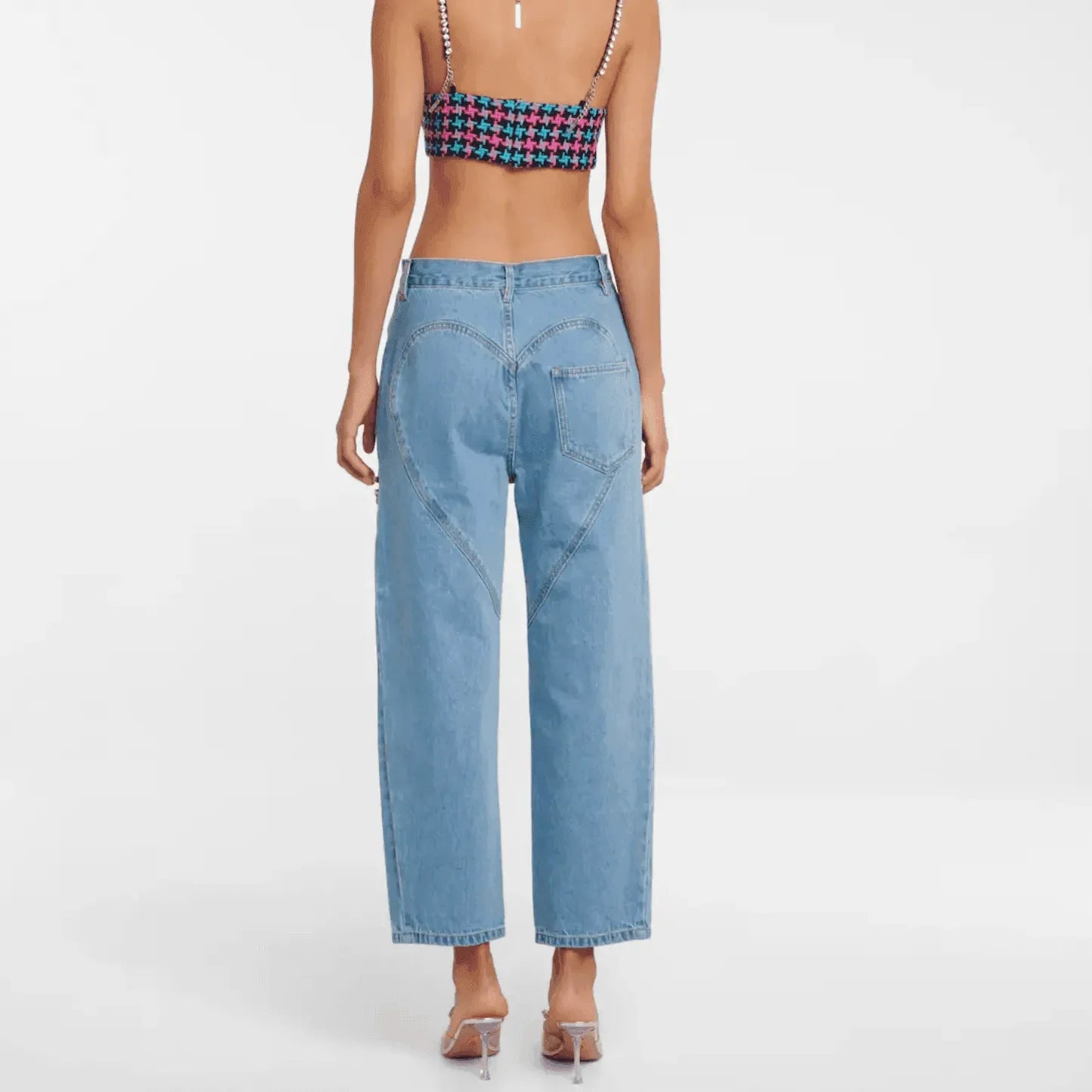 Crochet crop top with blue denim heart-detail jeans.
