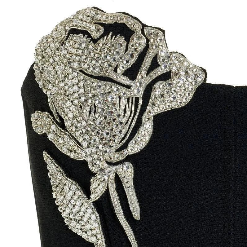 Black dress with crystal floral embellishment, elegant evening attire