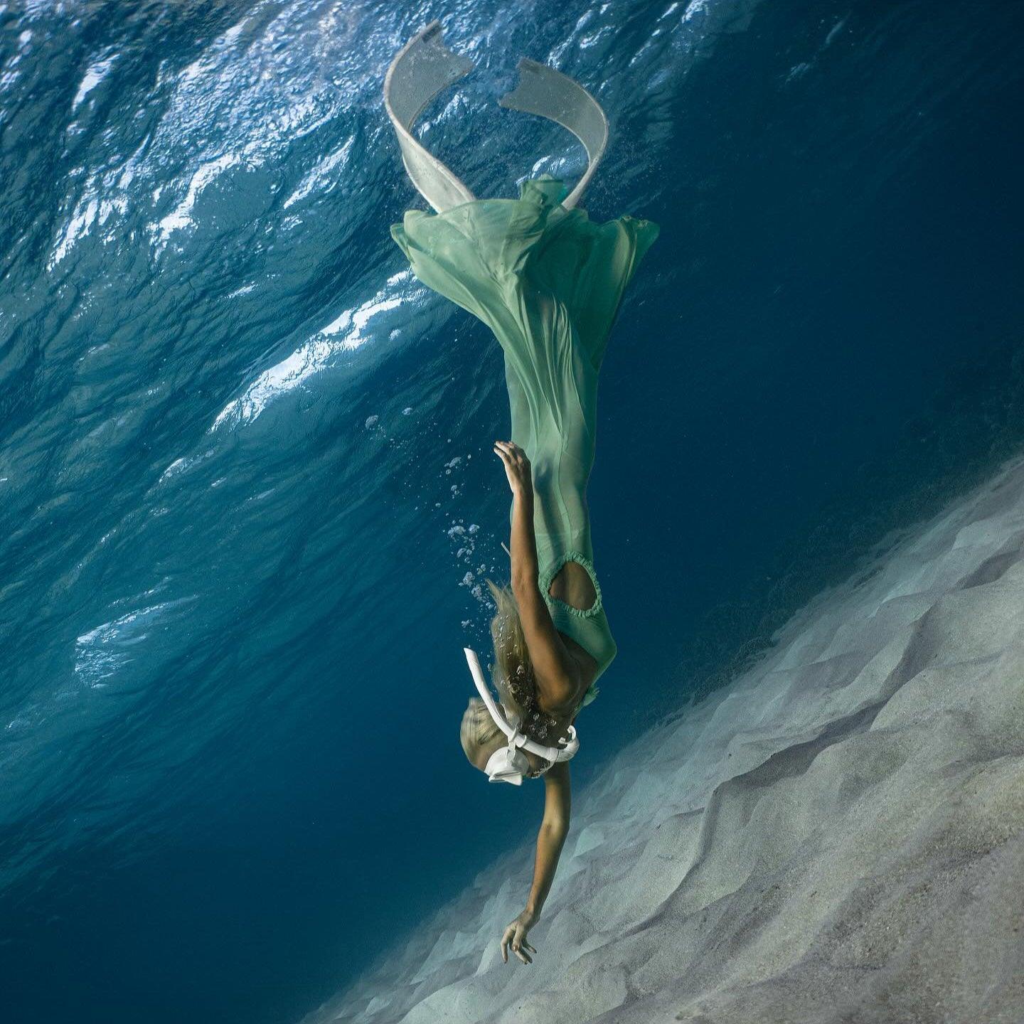 Emerald green flowing gown with mermaid-style design, fantasy-inspired look