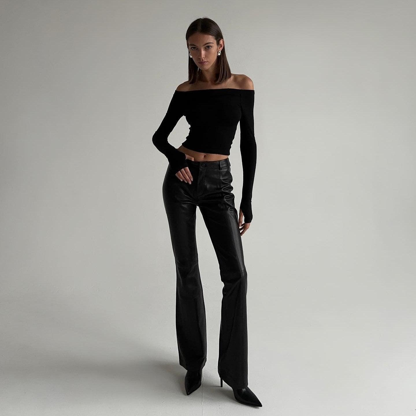 Off-shoulder long-sleeve crop top with high-waisted leather pants, chic night-out ensemble