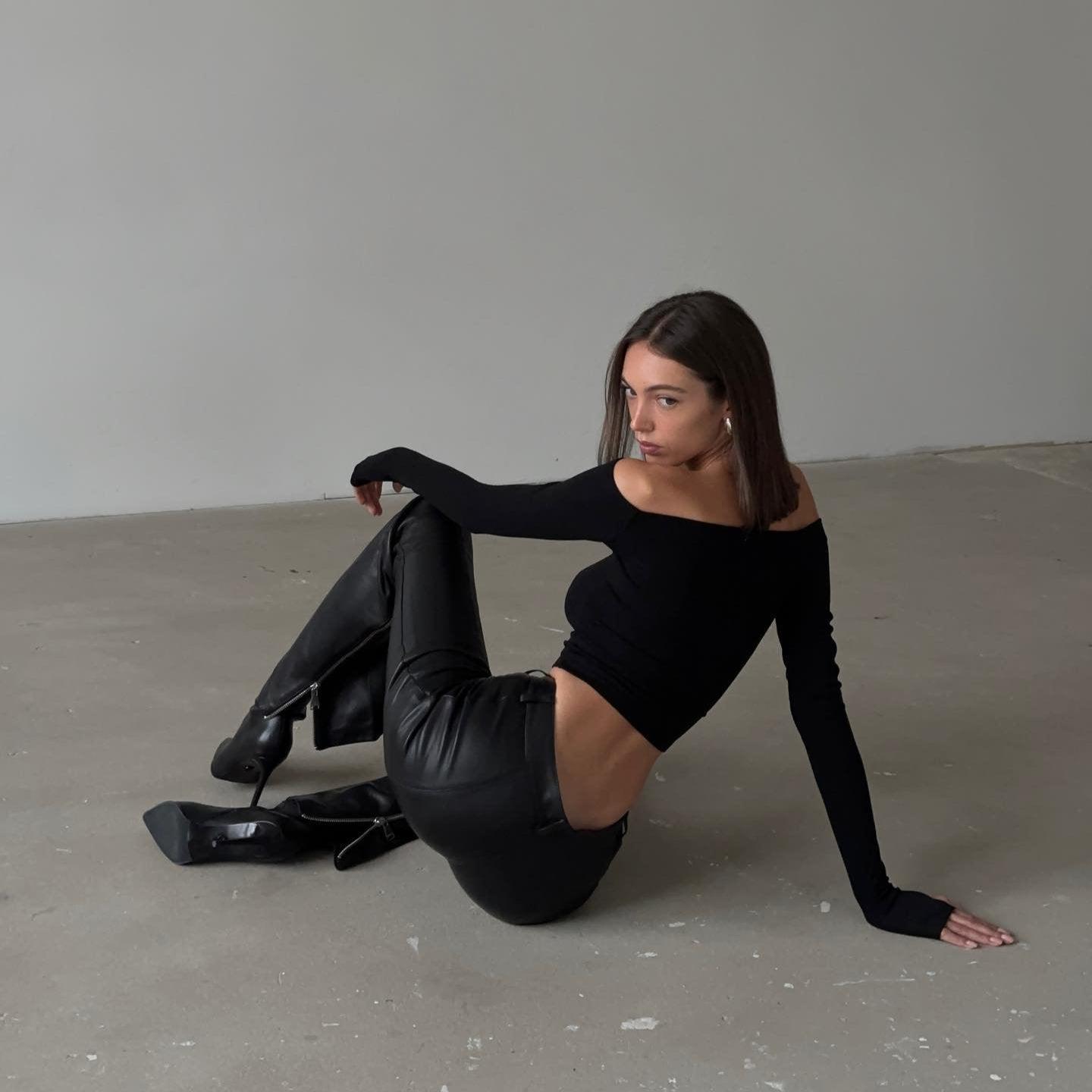 Off-the-shoulder long-sleeve top and high-waisted leather pants, edgy night-out style