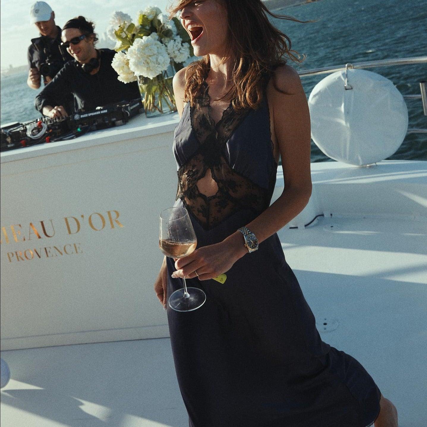 Lace and satin evening dress with floral details.