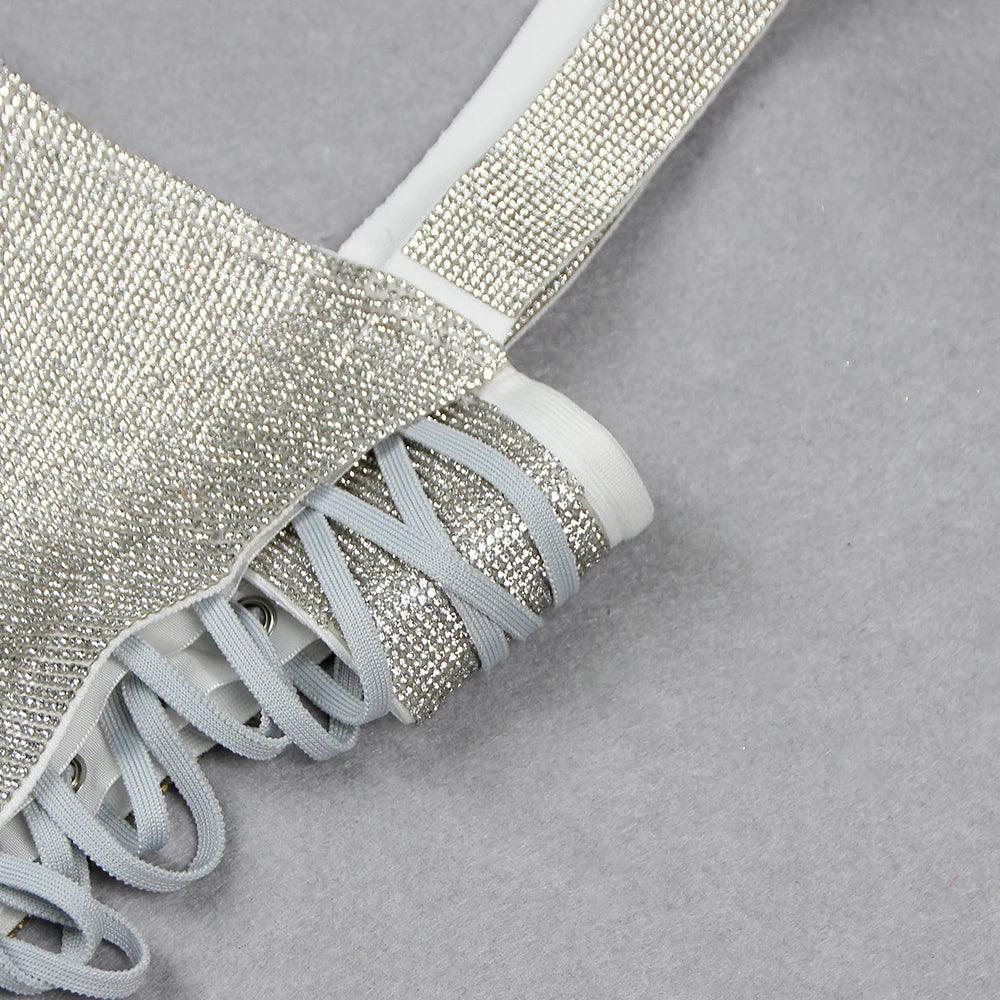 Rhinestone-embellished lace-up top, sparkling partywear.