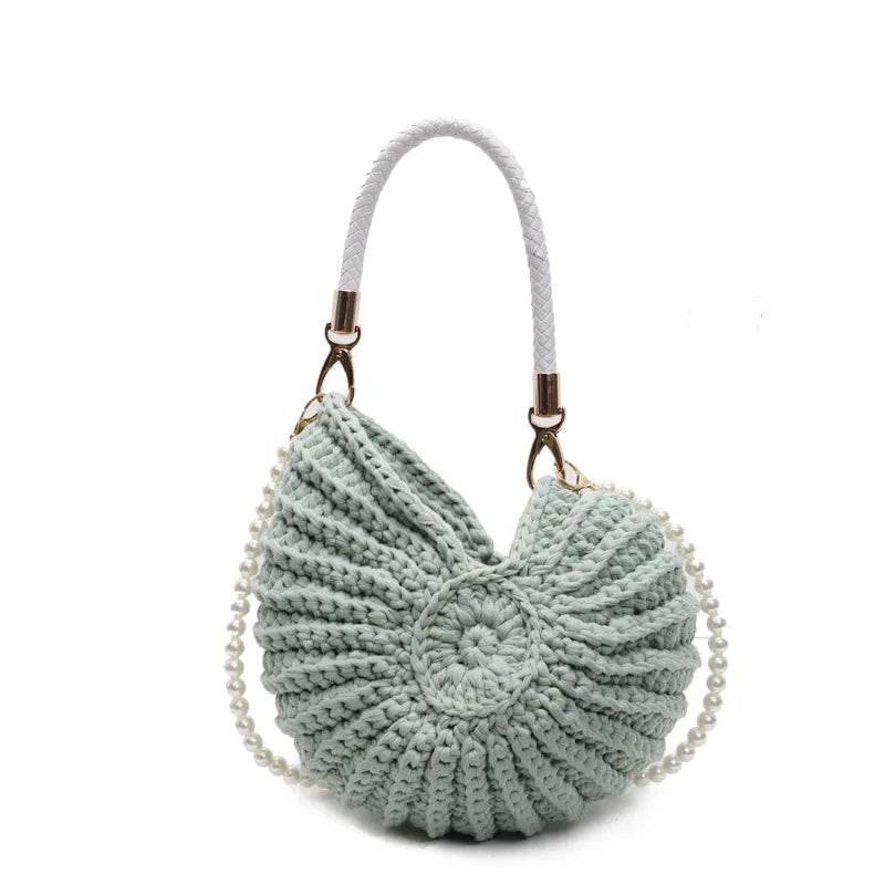 Knitted seashell-shaped handbag with pearl and rope handle.