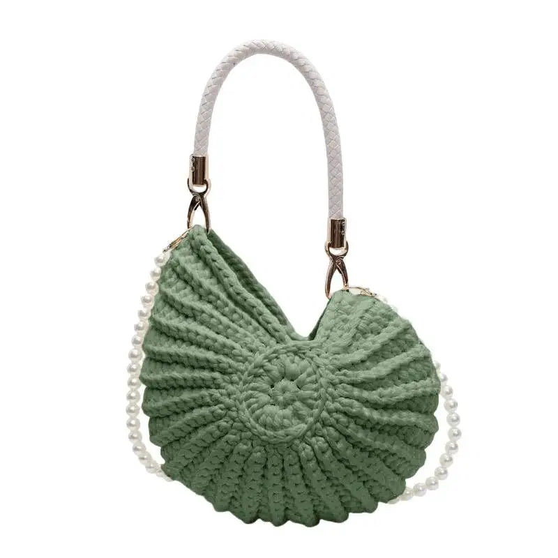 Green seashell-shaped crochet handbag with pearl and braided handle, unique accessory piece