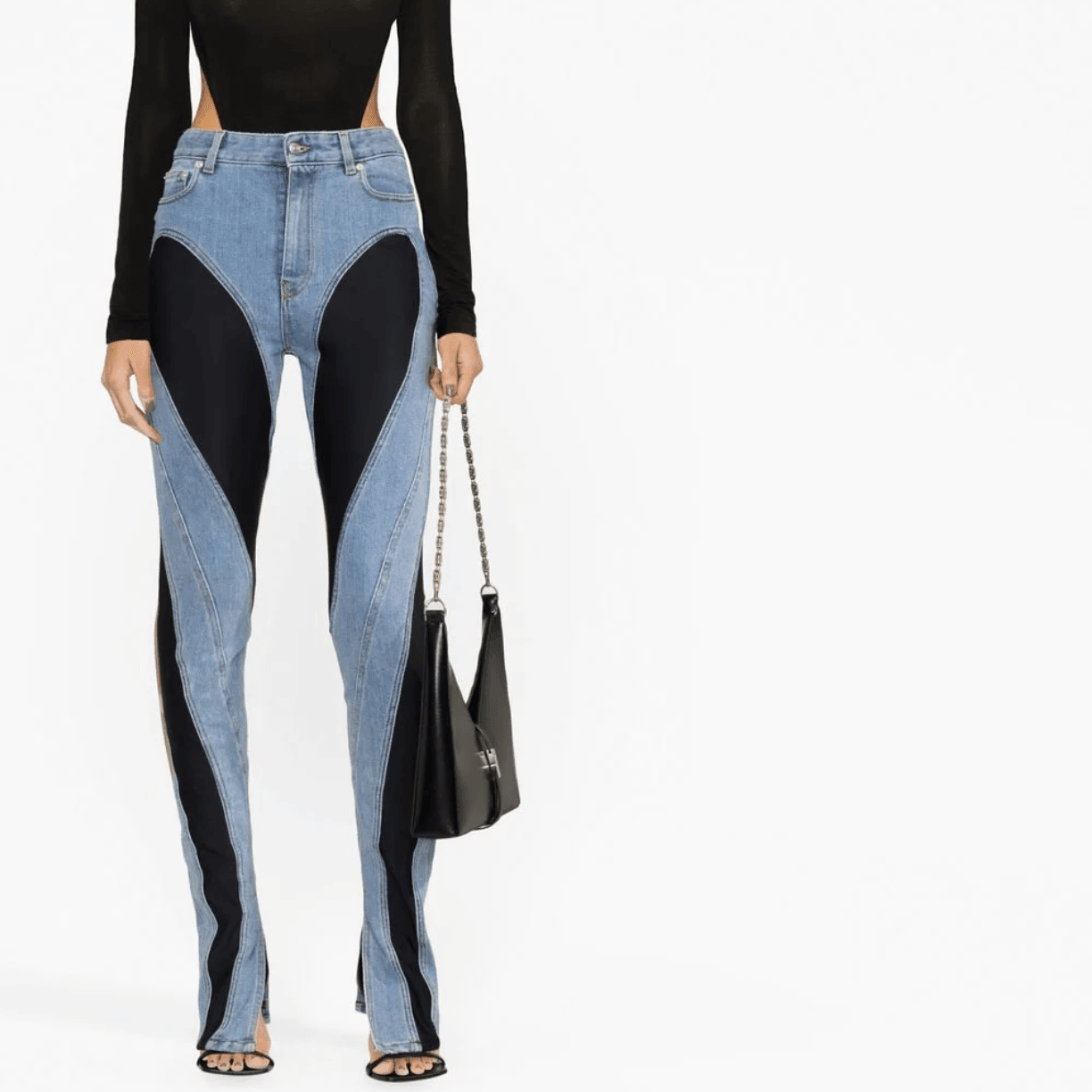 Denim and black contrast panel pants with black top and bag.
