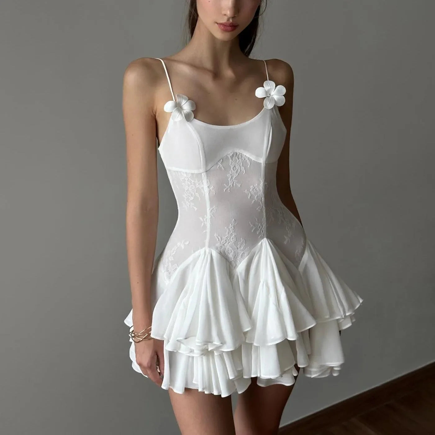 Lace and chiffon mini dress with floral strap details, romantic evening look.
