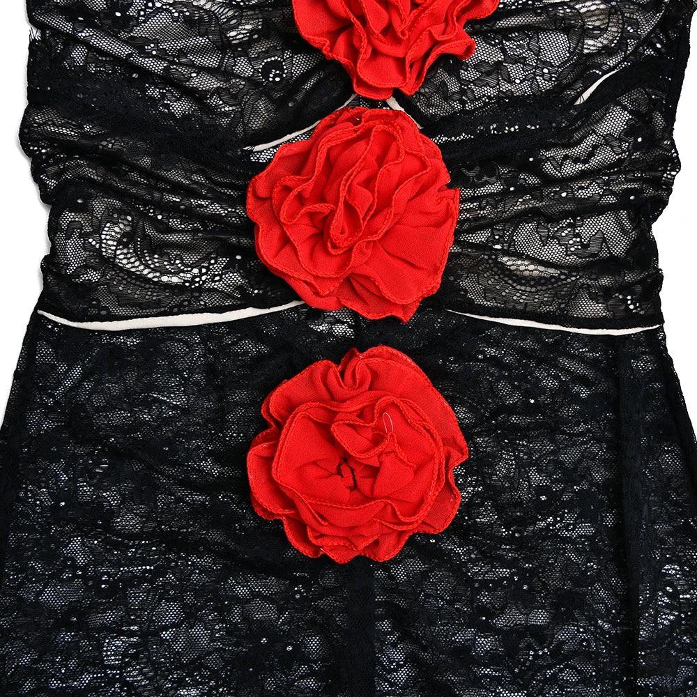 Black lace dress with red floral accents, elegant evening wear