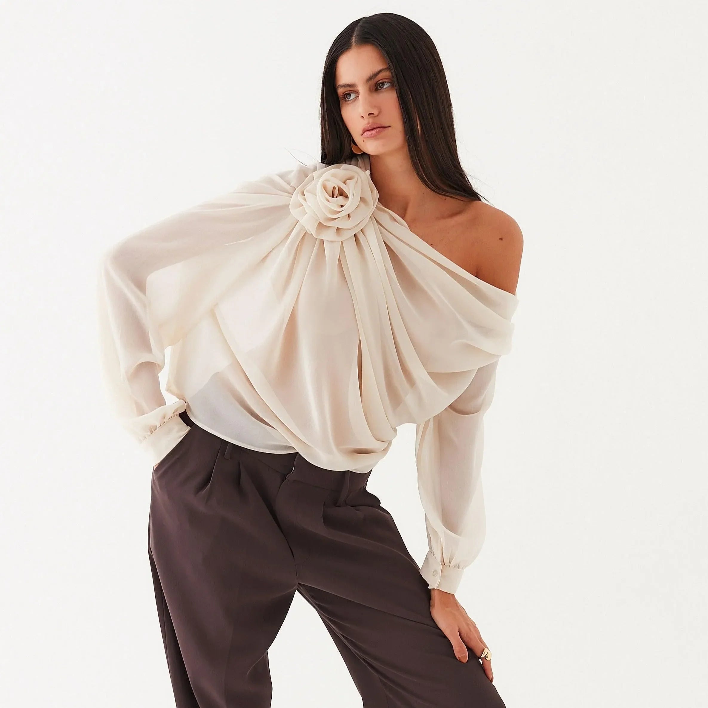 Off-shoulder draped top with floral detail, elegant statement piece