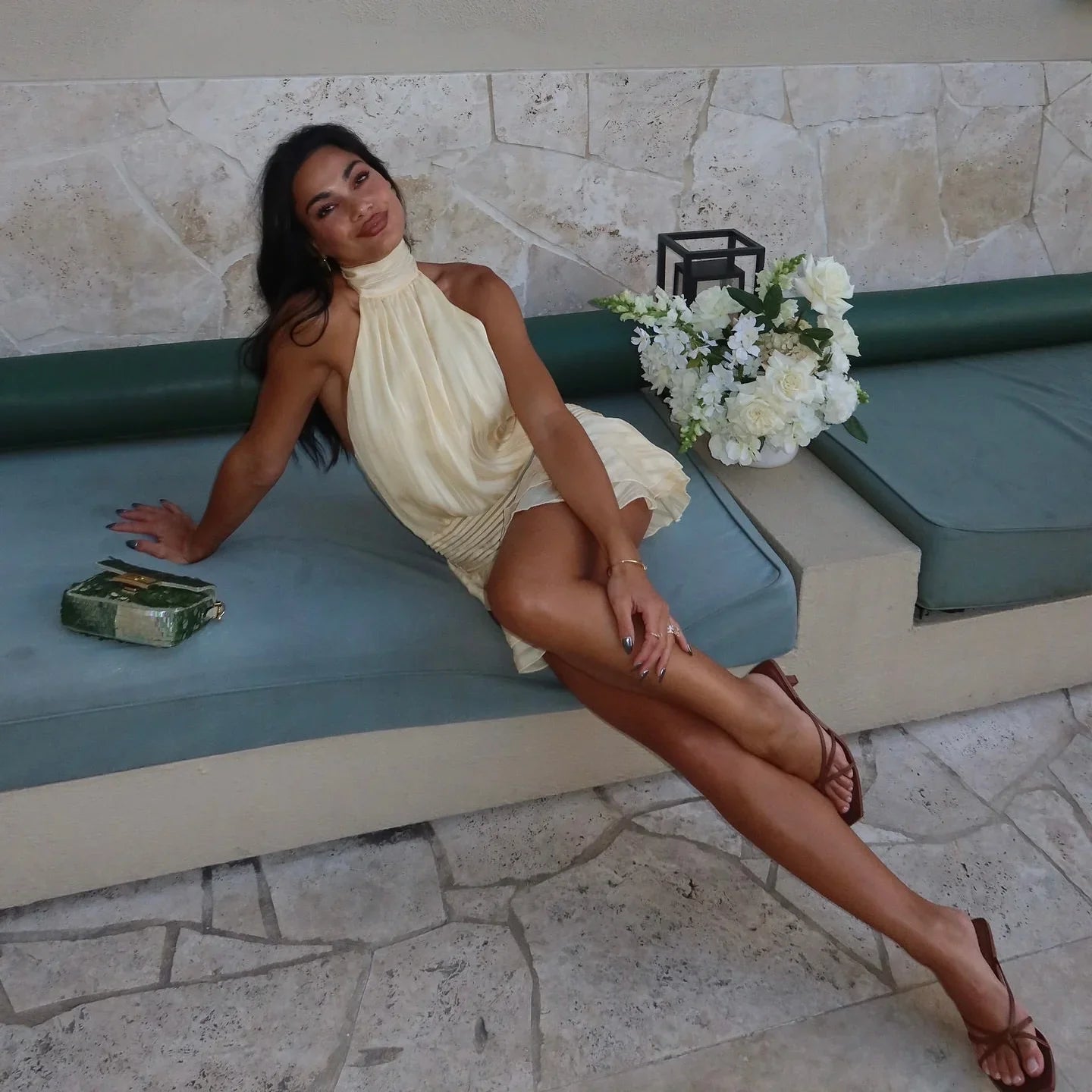 Halter-neck pleated mini dress with ruched detail, summer party outfit.