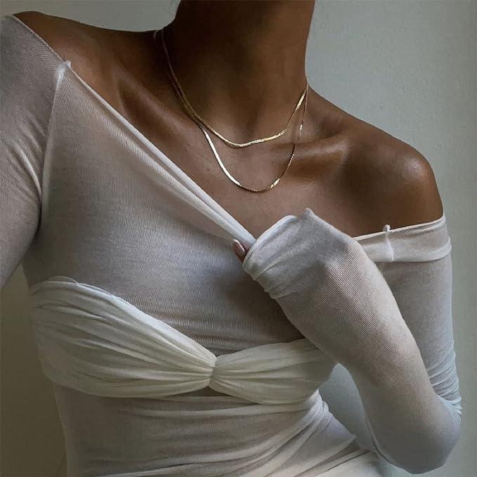 Off-the-shoulder sheer mesh top with layered design, elegant evening style