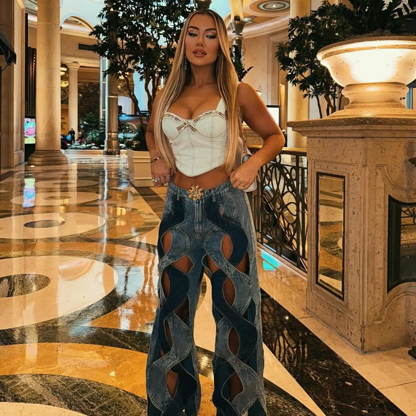Corset-style top with cut-out denim pants, trendy fashion ensemble
