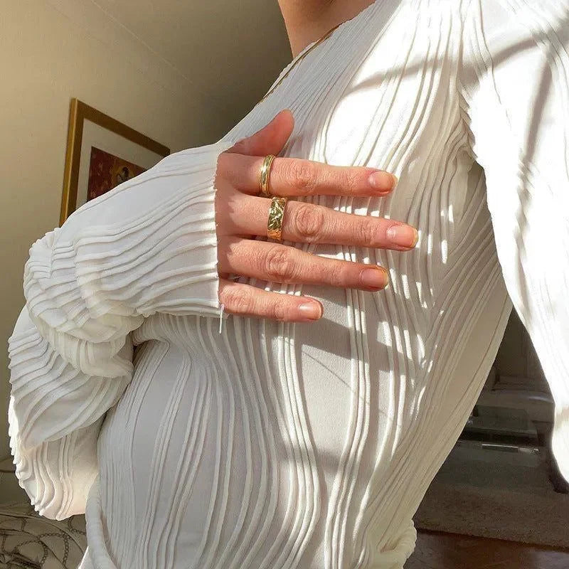Pleated white long-sleeve top, elegant daywear style