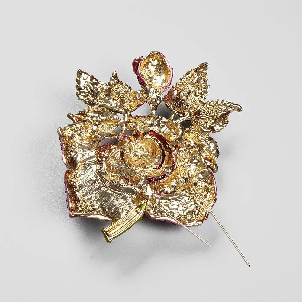 Gold floral brooch with intricate detailing, statement accessory.