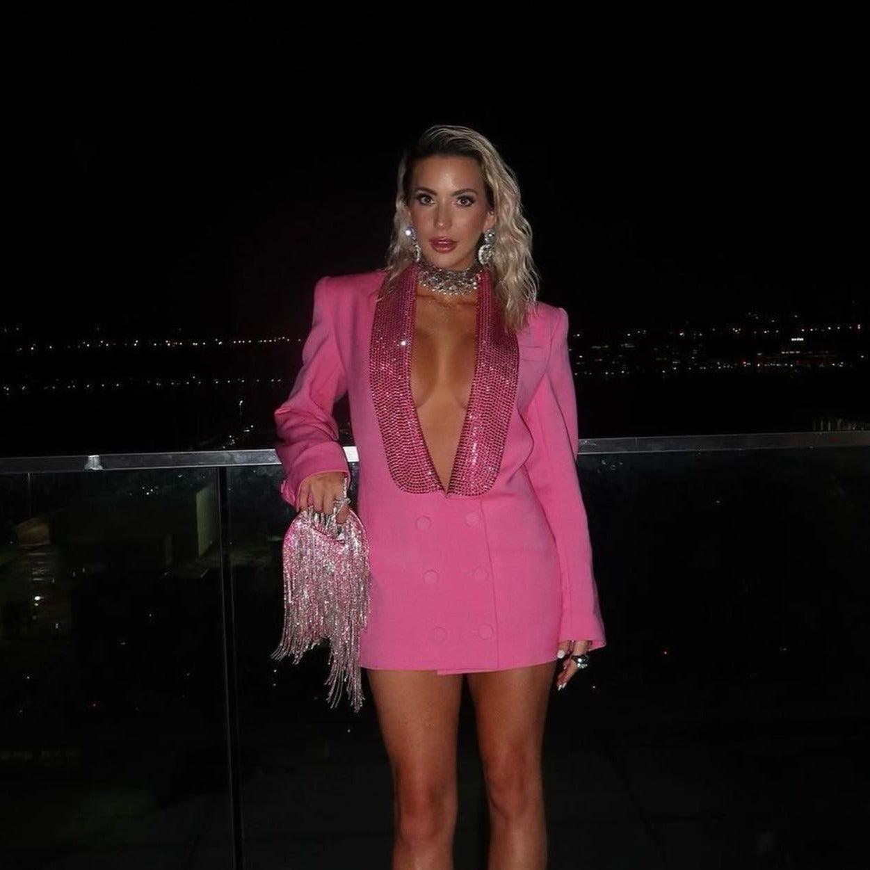 Pink blazer-style mini dress with sequin detailing, paired with a fringed statement bag, ideal for