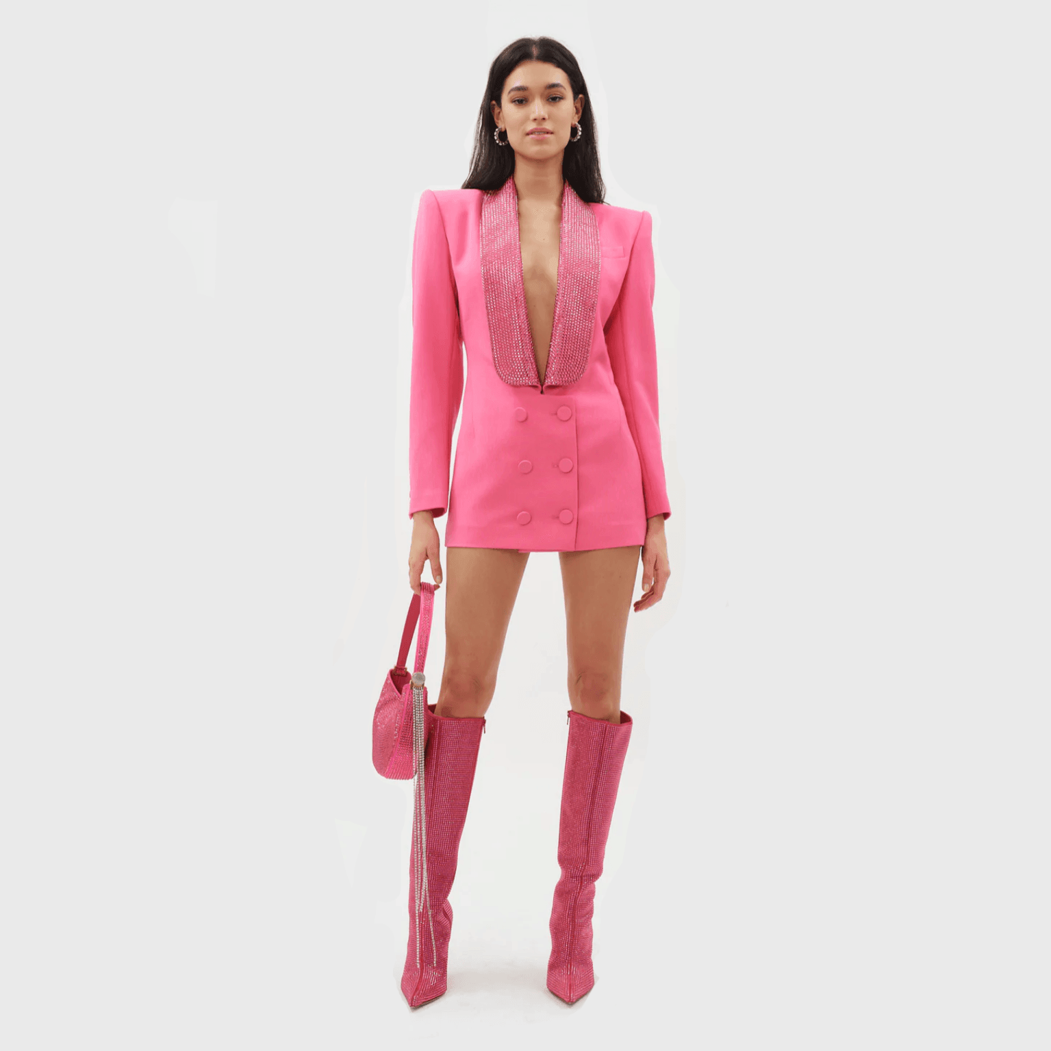 Pink blazer-style mini dress with deep neckline and rhinestone detailing, paired with matching