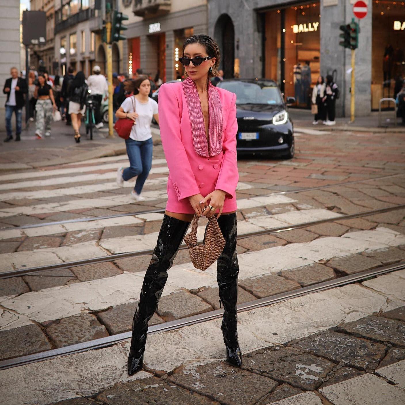 Pink blazer-style mini dress with glittering collar, paired with patent thigh-high boots and a chic