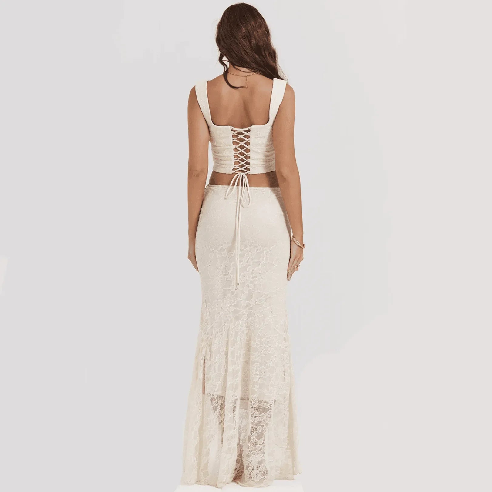 Lace backless two-piece set with a lace-up top and matching maxi skirt, elegant evening attire.