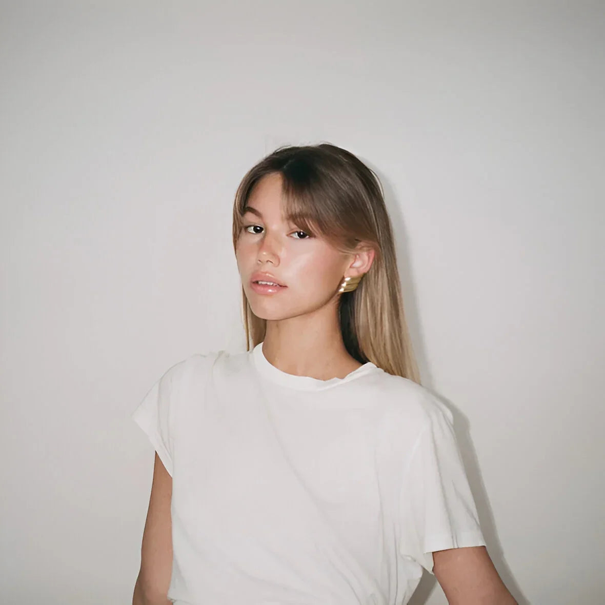 Plain white short-sleeve top with minimalistic style.