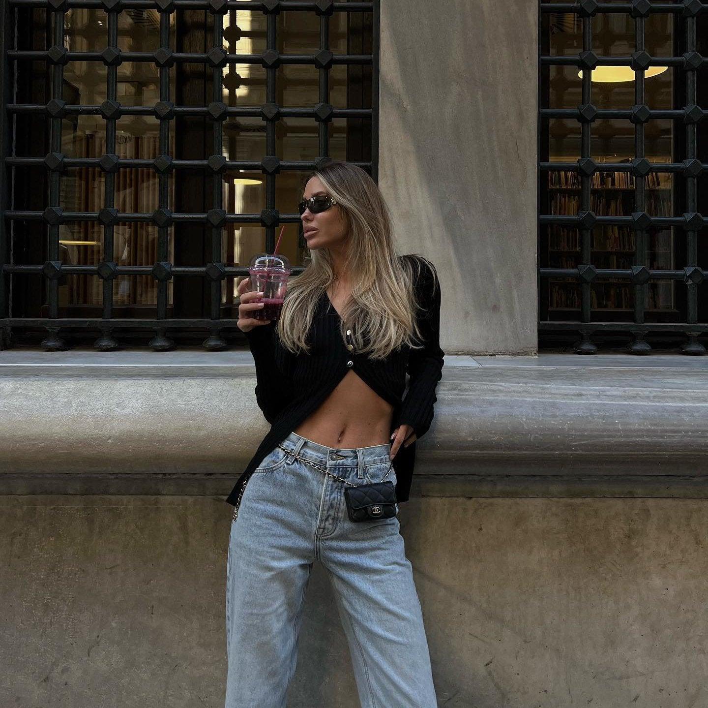 Ribbed black crop top paired with light wash high-waisted jeans, casual street style.