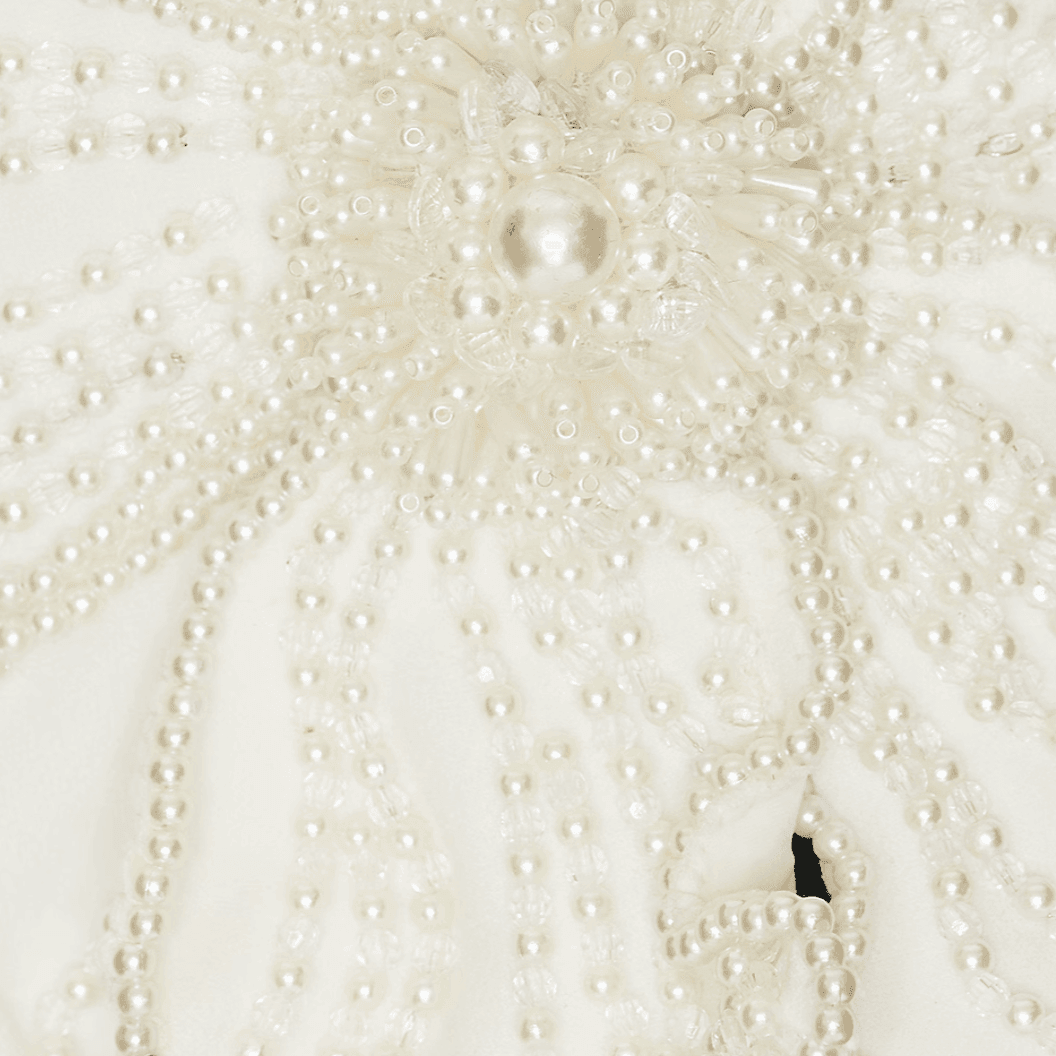 Pearl-embellished fabric detail, sophisticated textured design.