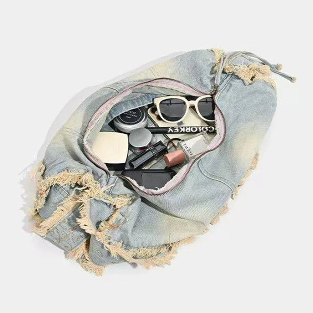 Frayed denim bag with makeup and accessories, casual everyday use.