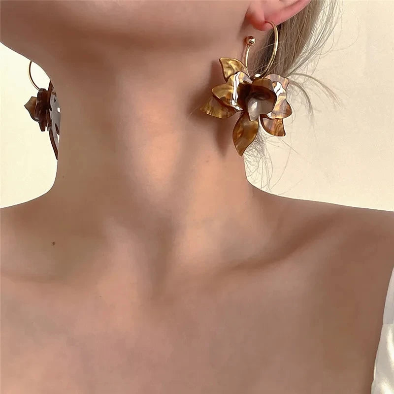 Gold flower hoop earrings.