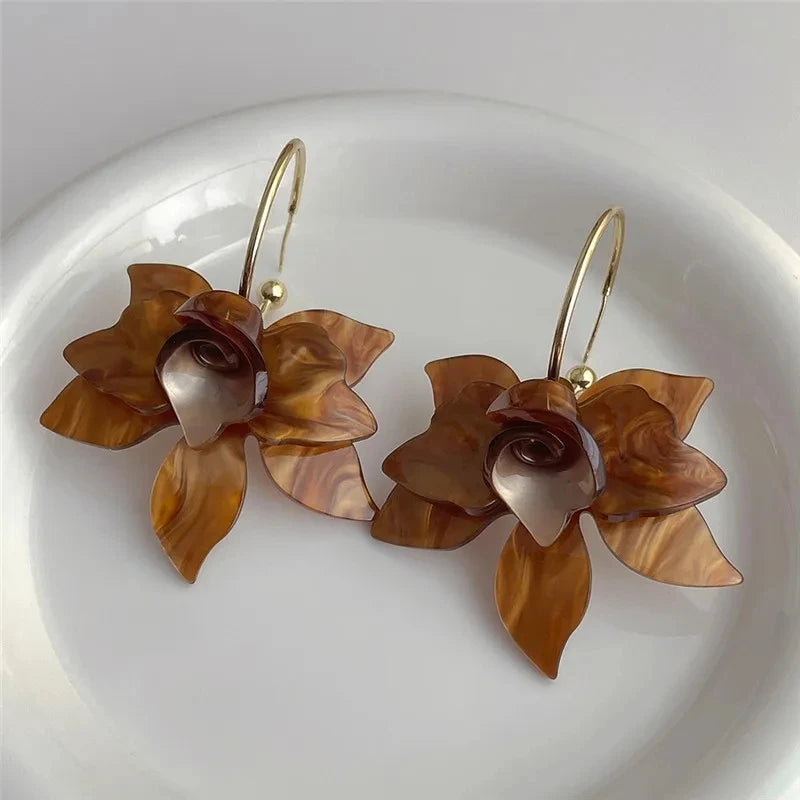 Floral resin drop earrings with gold-tone hooks, elegant statement accessory.