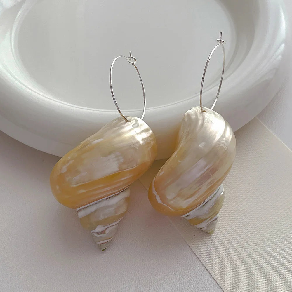 Shell hoop earrings with iridescent finish, statement accessories