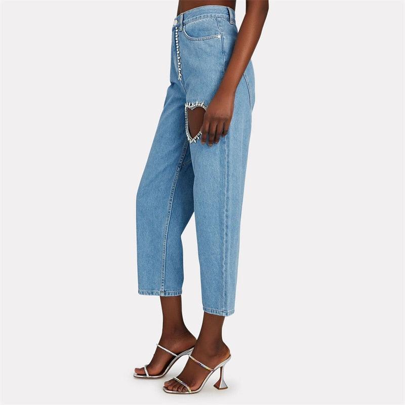 High-waisted jeans with crystal embellishments and side cut-outs, casual chic style