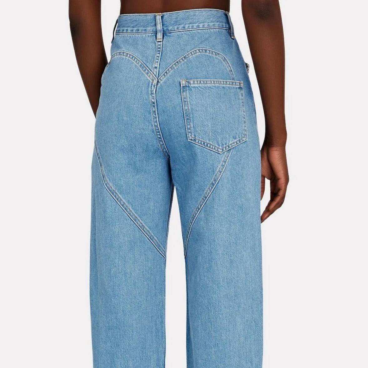 High-waisted denim jeans with heart-shaped stitching detail, casual wear.