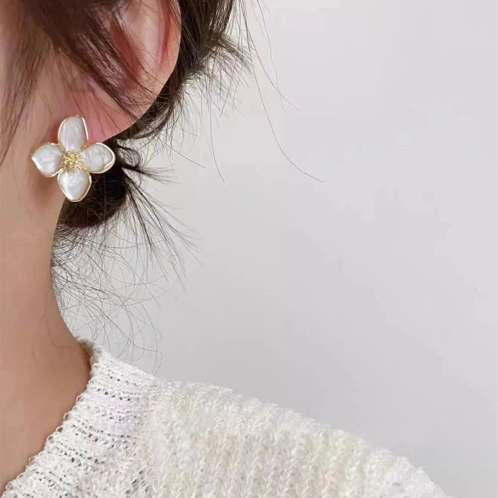 Floral pearl statement earrings with gold accents, elegant accessory.