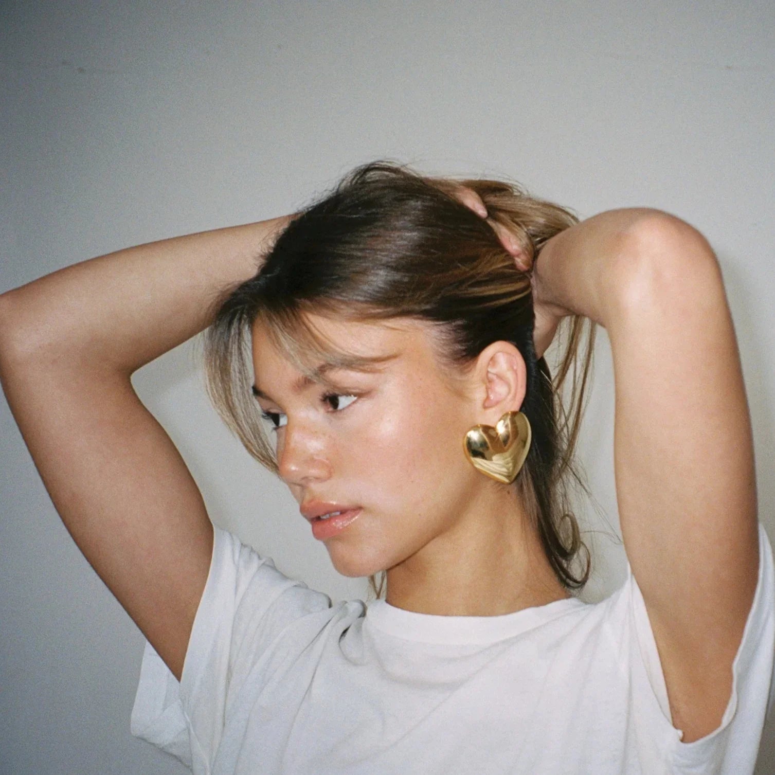 Gold heart-shaped statement earrings, versatile accessory piece