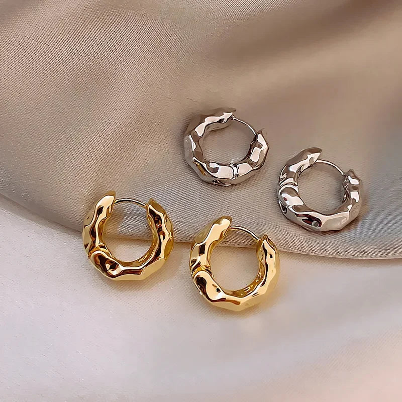 chunky gold and silver hoop earrings with textured design