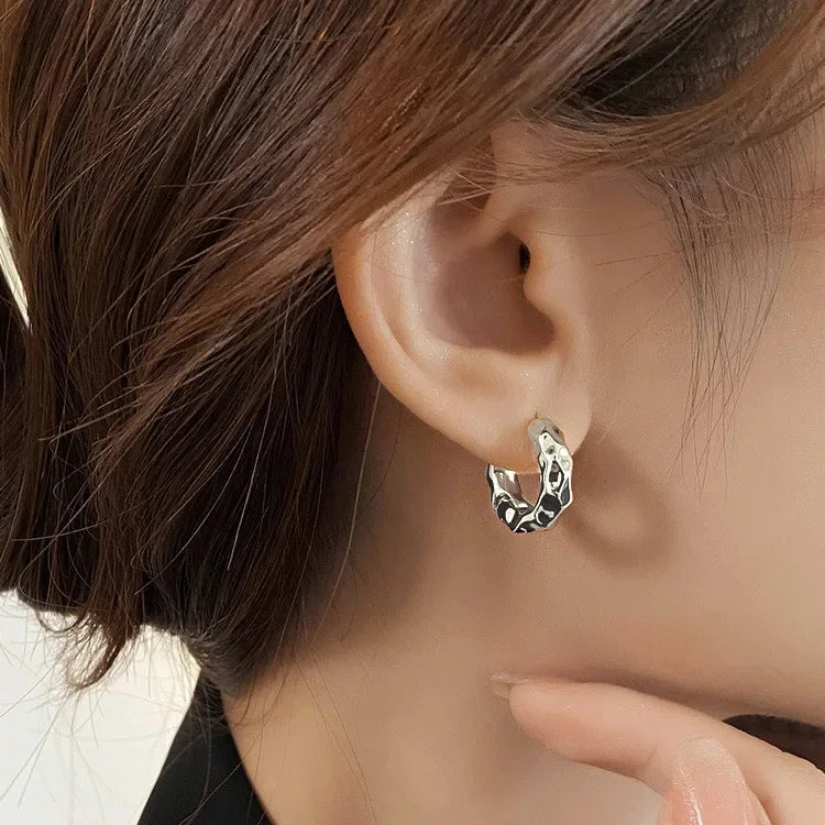 chunky silver hoop earring with abstract design