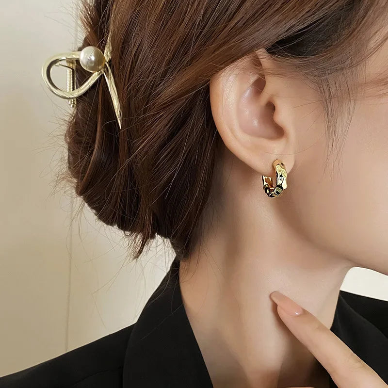 gold hoop earrings with pearl-accented hair clip