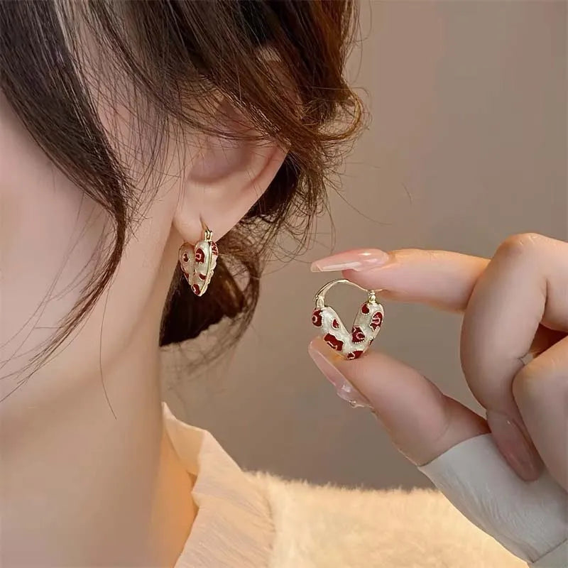 heart-shaped hoop earrings with red accents