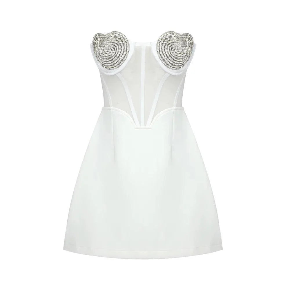 White bustier mini dress with heart-shaped embellishments, featuring sheer panels and a fitted silhouette, perfect for a...